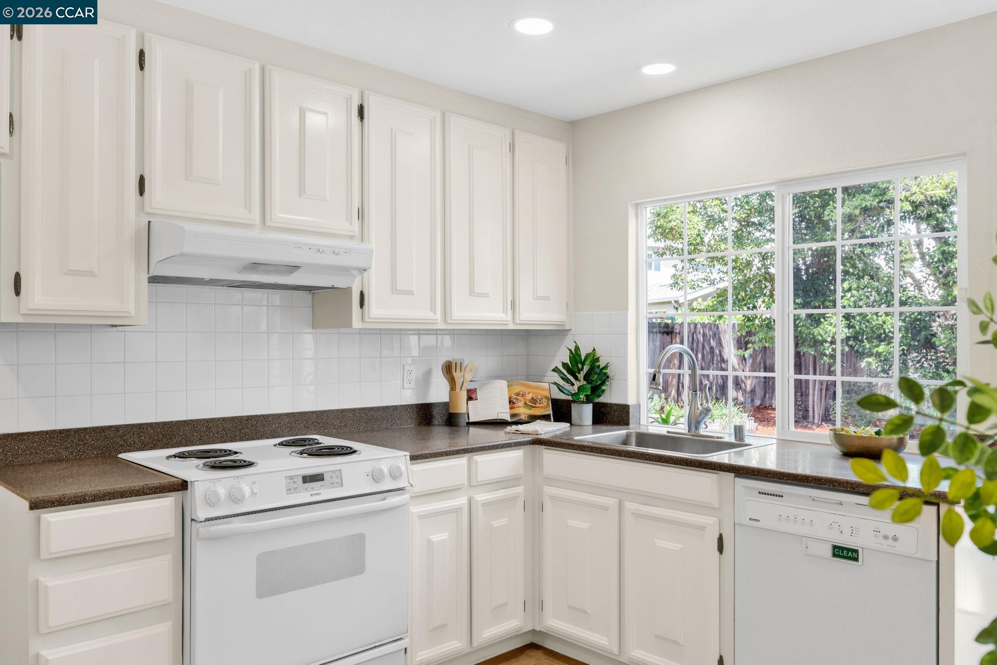 32 Yale Court San Ramon, CA 94583 - Photo 15 of 40 a kitchen with stainless steel appliances white cabinets and a window