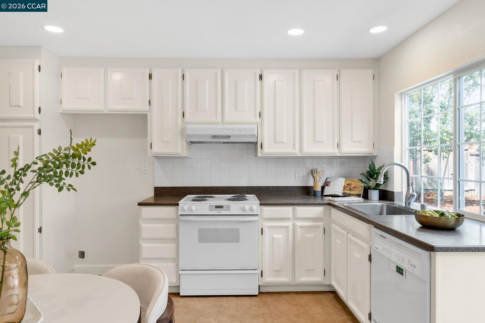 32 Yale Court San Ramon, CA 94583 - Photo 16 of 40 a kitchen with cabinets appliances a sink and a window