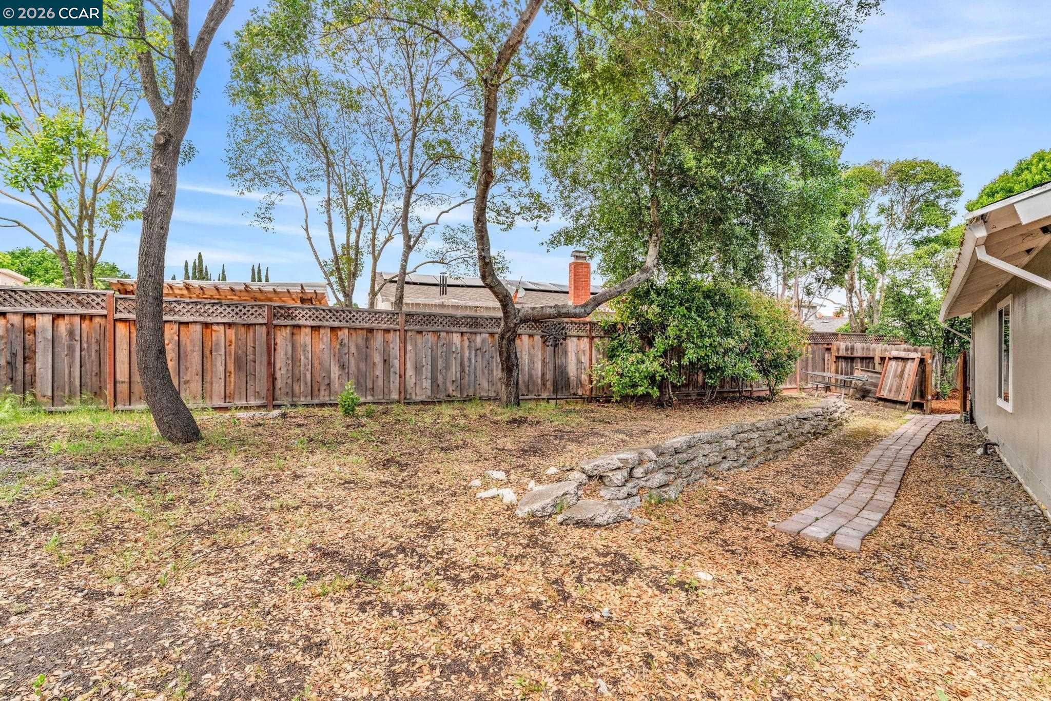 32 Yale Court San Ramon, CA 94583 - Photo 39 of 40 a backyard of a house with a tree and wooden fence