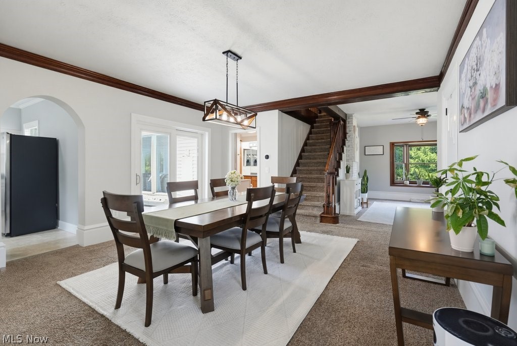 23055 Snell Road Columbia Station, OH 44028 - Photo 17 of 50 Dining area featuring a wood-finish beam ceiling, modern chandelier, and broad wall archway