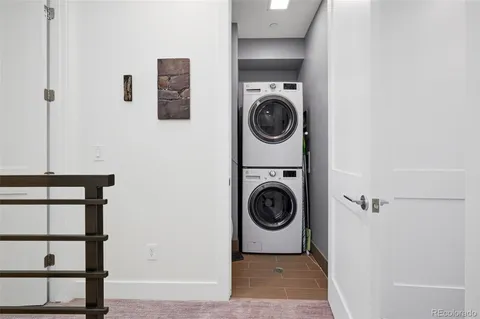 a bedroom with bed and a chandelier