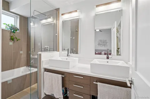 a bathroom with a bathtub sink and mirror