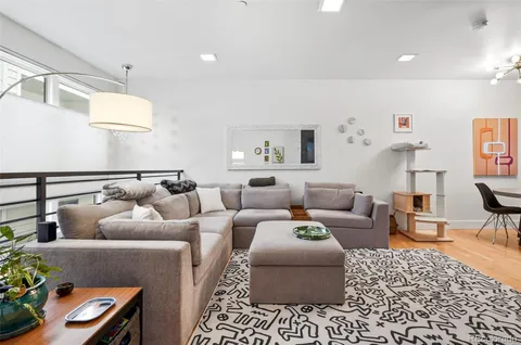 a living room with furniture and a rug