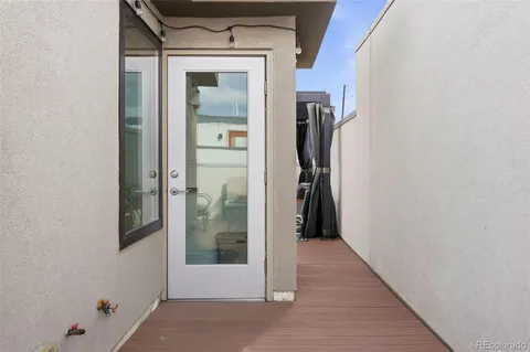 a view of balcony with couch and chairs