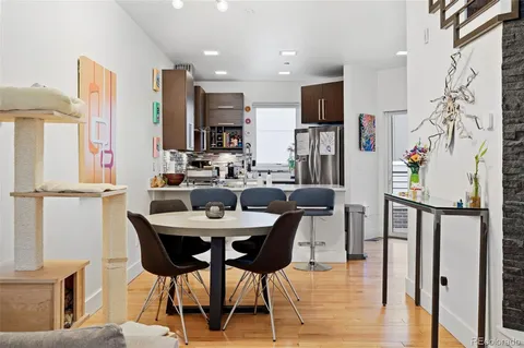 a dining room with furniture and wooden floor