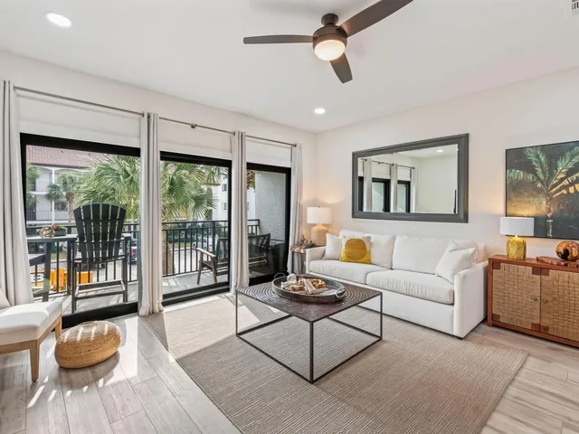 a large white kitchen with lots of counter space a refrigerator and cabinets