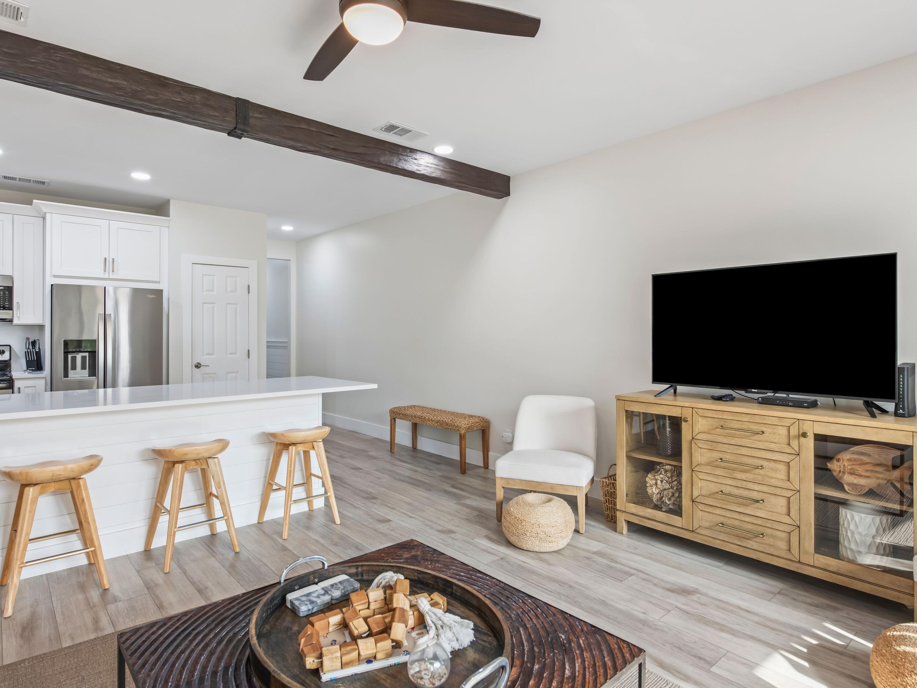 3604 East County Highway 30A, Unit D5 Santa Rosa Beach, FL 32459 - Photo 14 of 45 a living room with furniture and a flat screen tv