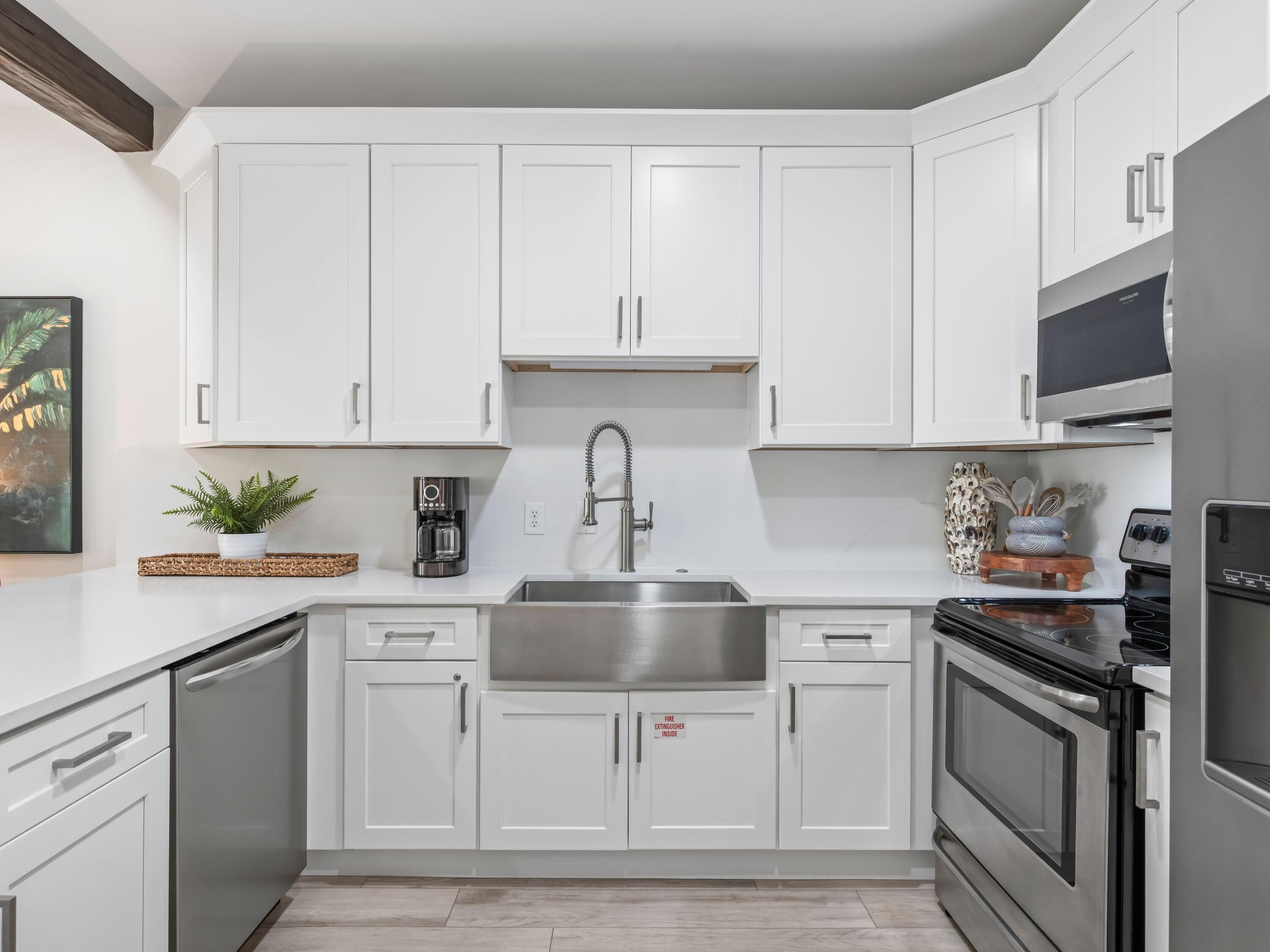 3604 East County Highway 30A, Unit D5 Santa Rosa Beach, FL 32459 - Photo 21 of 45 a kitchen with white cabinets and appliances