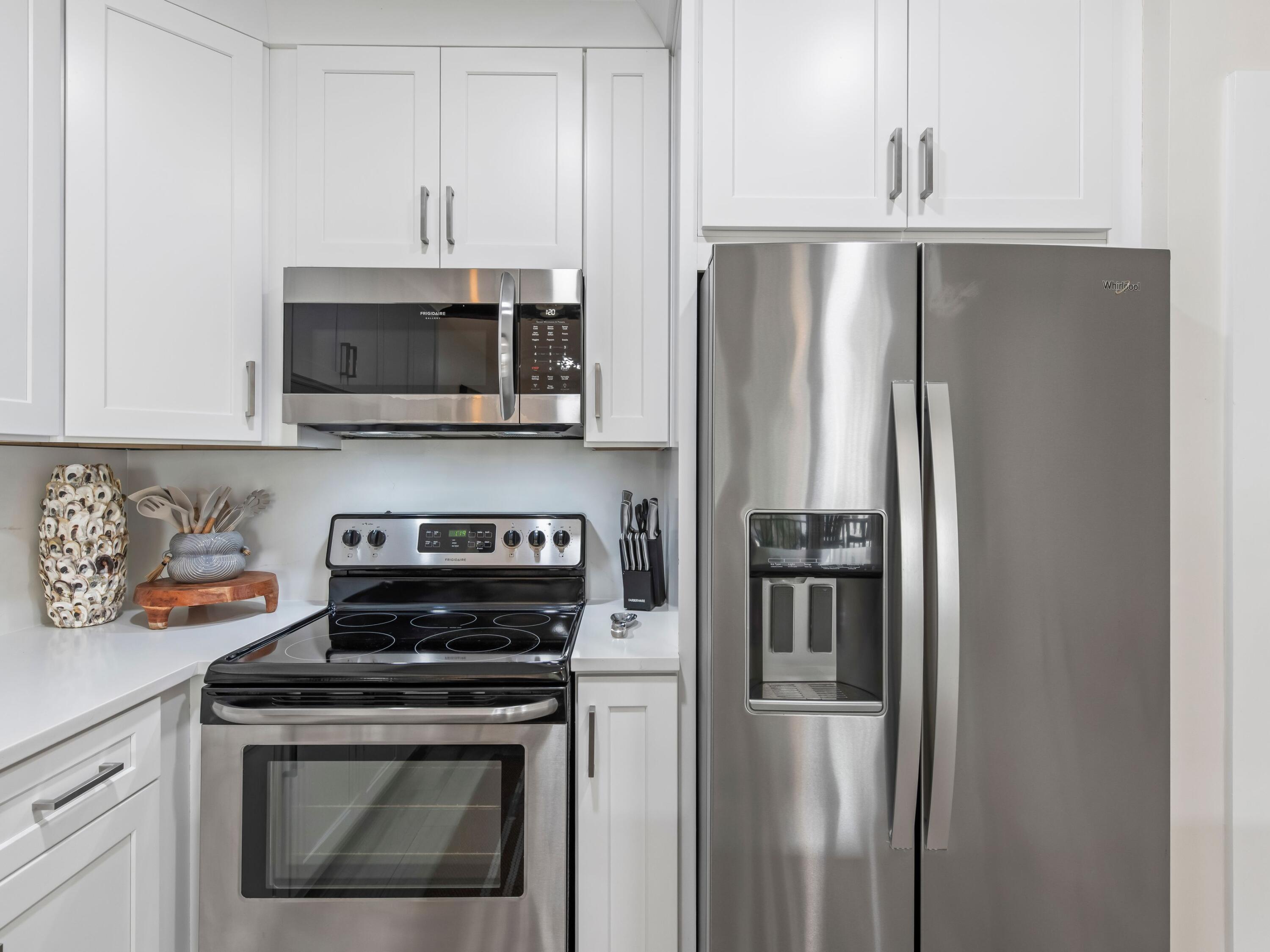 3604 East County Highway 30A, Unit D5 Santa Rosa Beach, FL 32459 - Photo 22 of 45 a kitchen with stainless steel appliances a refrigerator a stove a microwave and cabinets