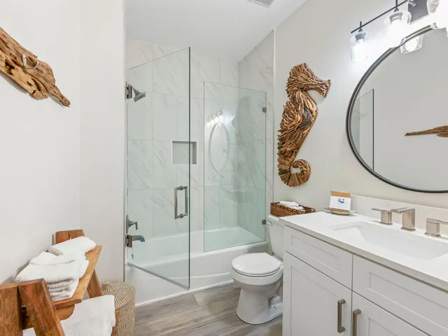 a kitchen with a refrigerator and white cabinets