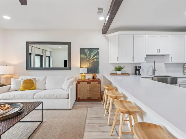 a living room with furniture and kitchen view