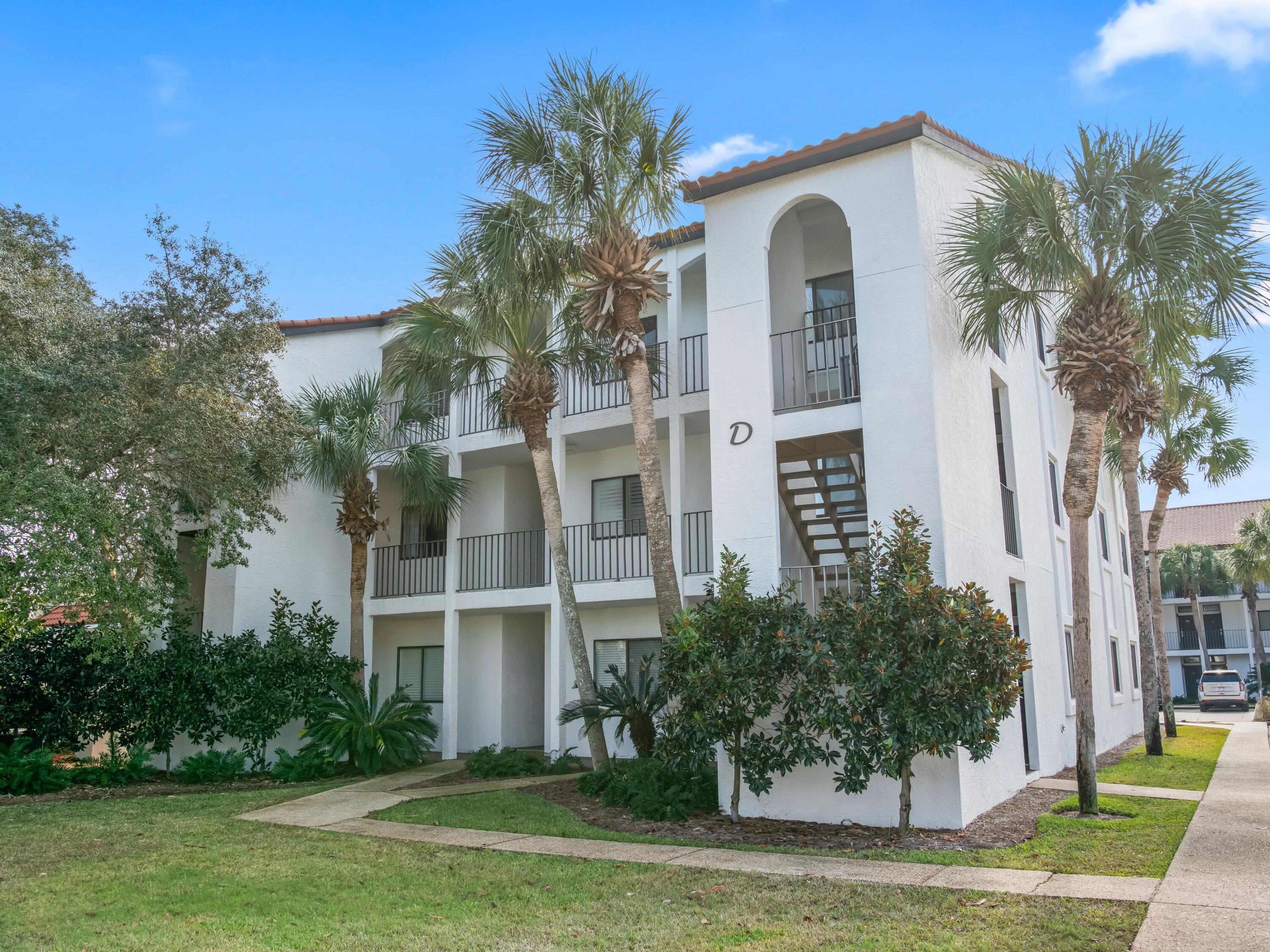 3604 East County Highway 30A, Unit D5 Santa Rosa Beach, FL 32459 - Photo 9 of 45 a front view of a house with a garden