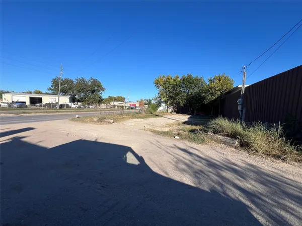 a view of a yard with a table and a chair