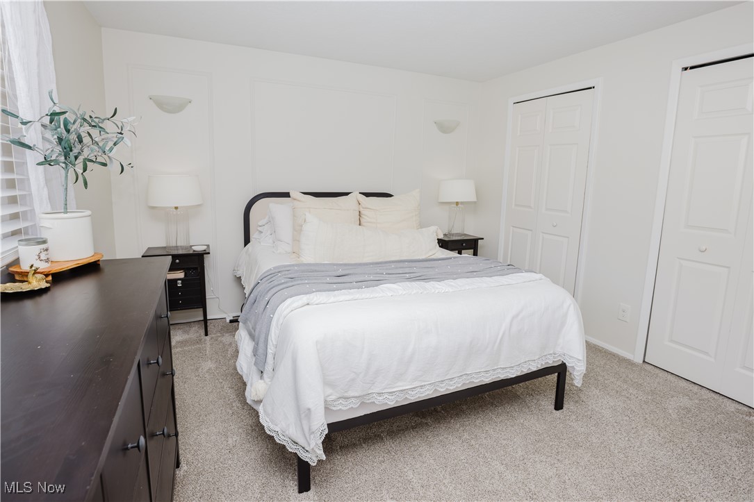 16940 Howe Road Strongsville, OH 44136 - Photo 25 of 33 Bedroom featuring light colored carpet and two closets