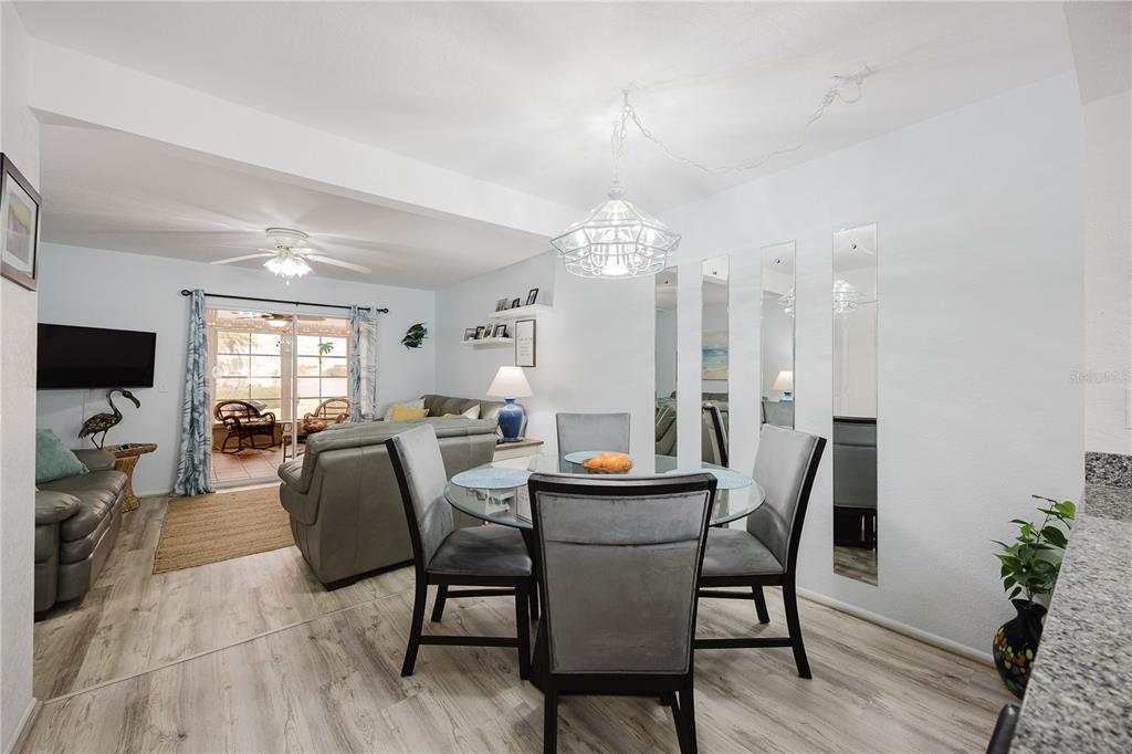 26282 Rampart Boulevard, Unit 204 Punta Gorda, FL 33983 - Photo 11 of 34 a view of a dining room with furniture and wooden floor
