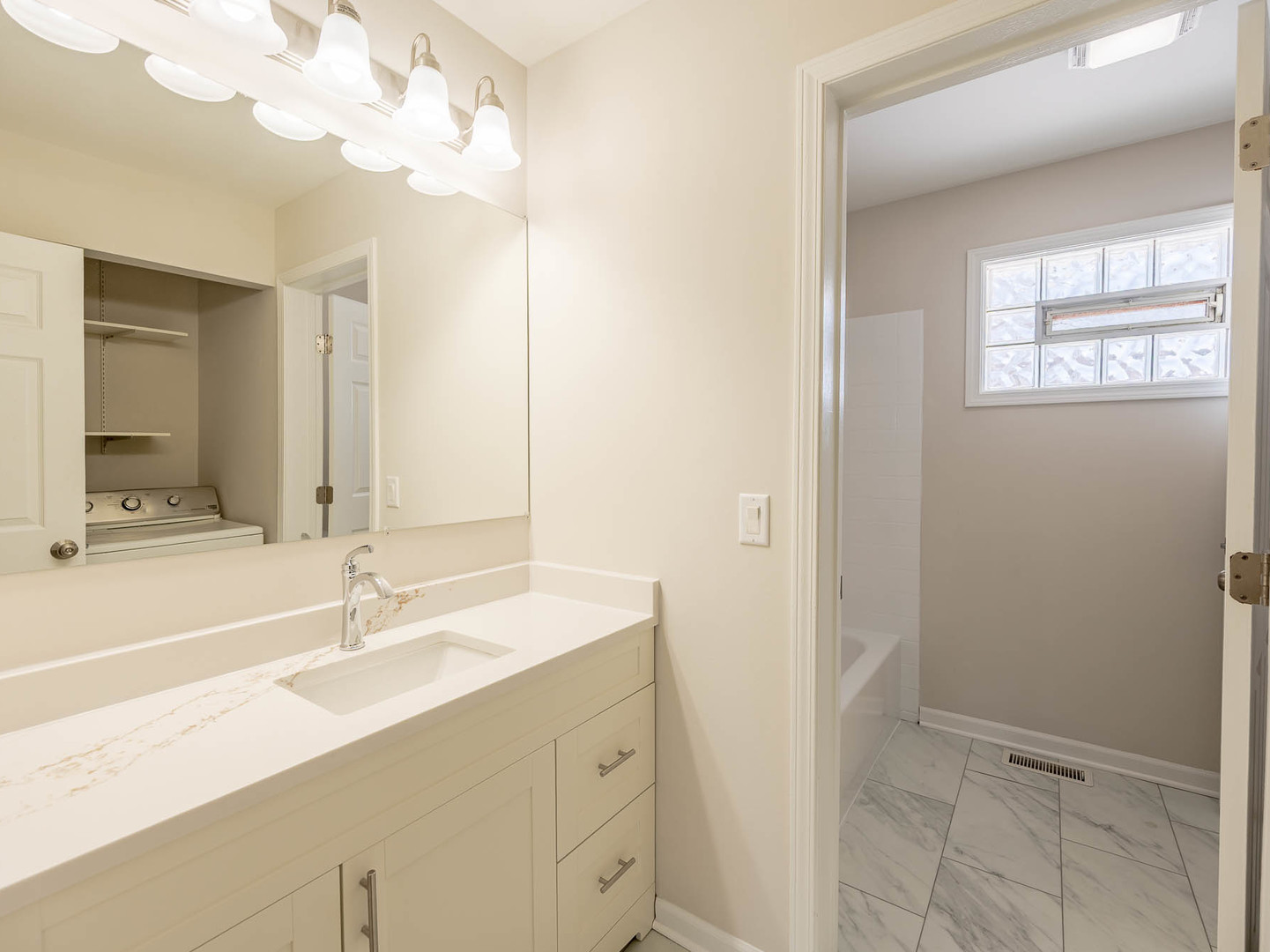 429 6th Street Wheeling, IL 60090 - Photo 15 of 17 a bathroom with a sink vanity and a mirror