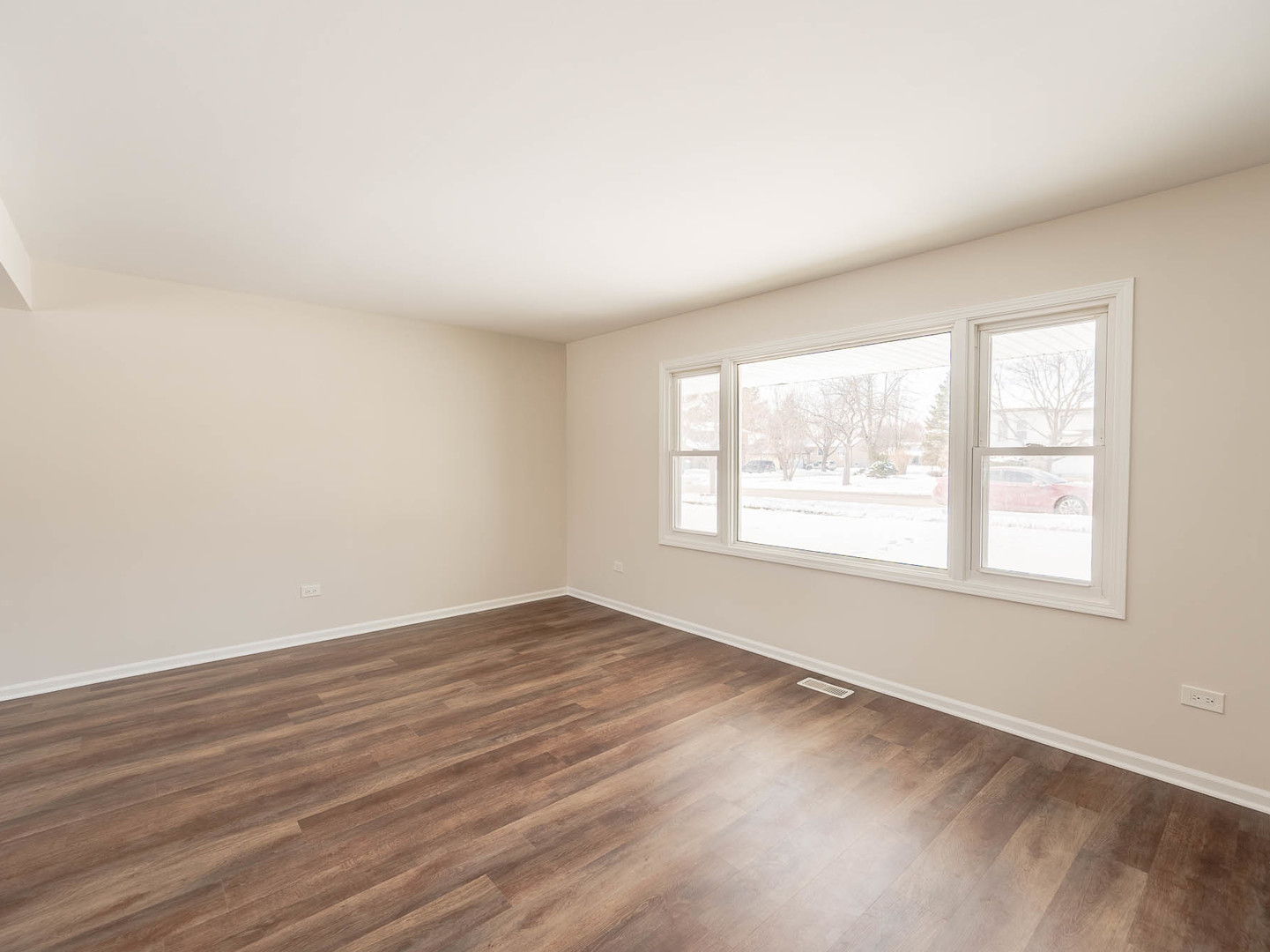 429 6th Street Wheeling, IL 60090 - Photo 3 of 17 an empty room with wooden floor and windows