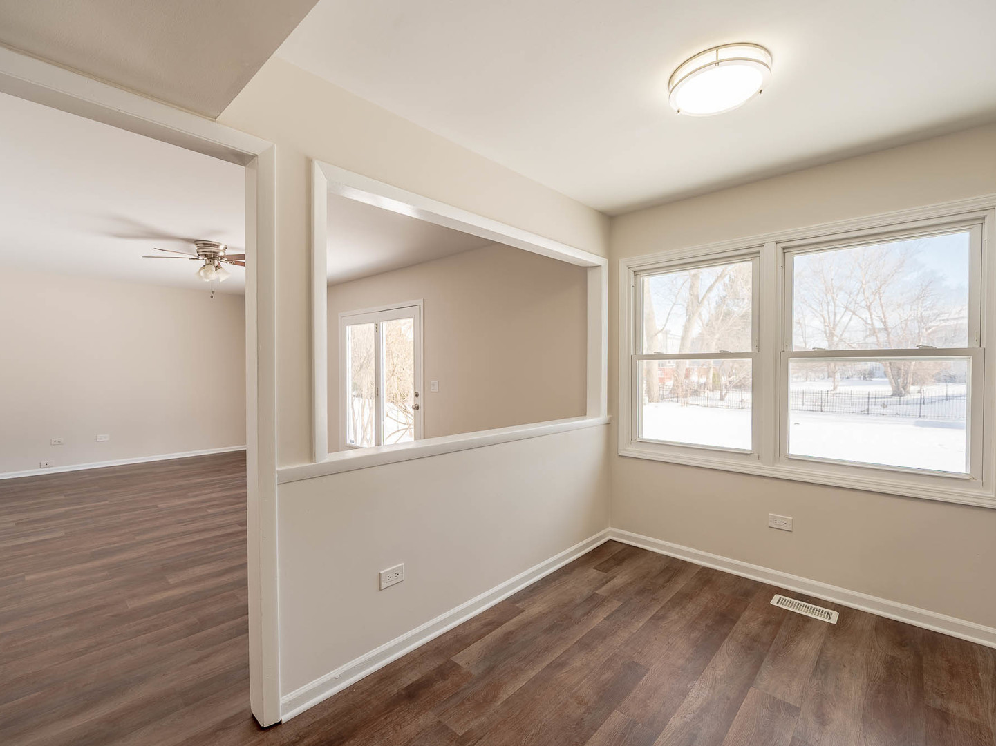 429 6th Street Wheeling, IL 60090 - Photo 9 of 17 an empty room with wooden floor and windows