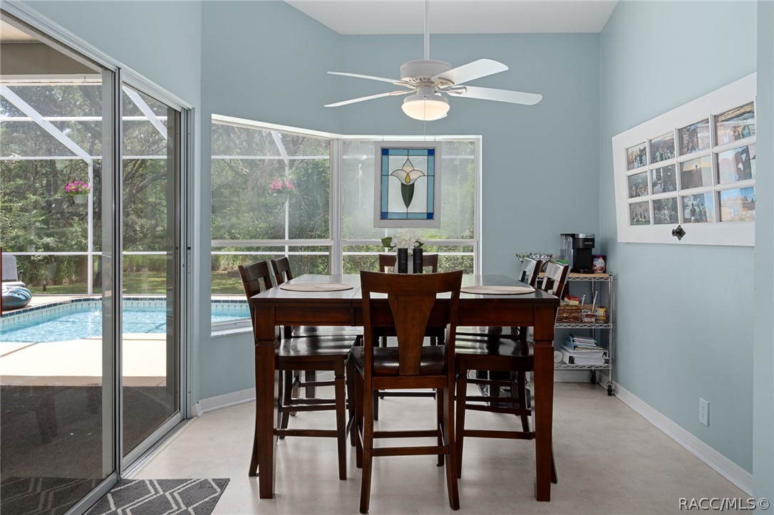 2460 West Pine Ridge Boulevard Beverly Hills, FL 34465 - Photo 9 of 47 a view of a dining room with furniture window and outside view