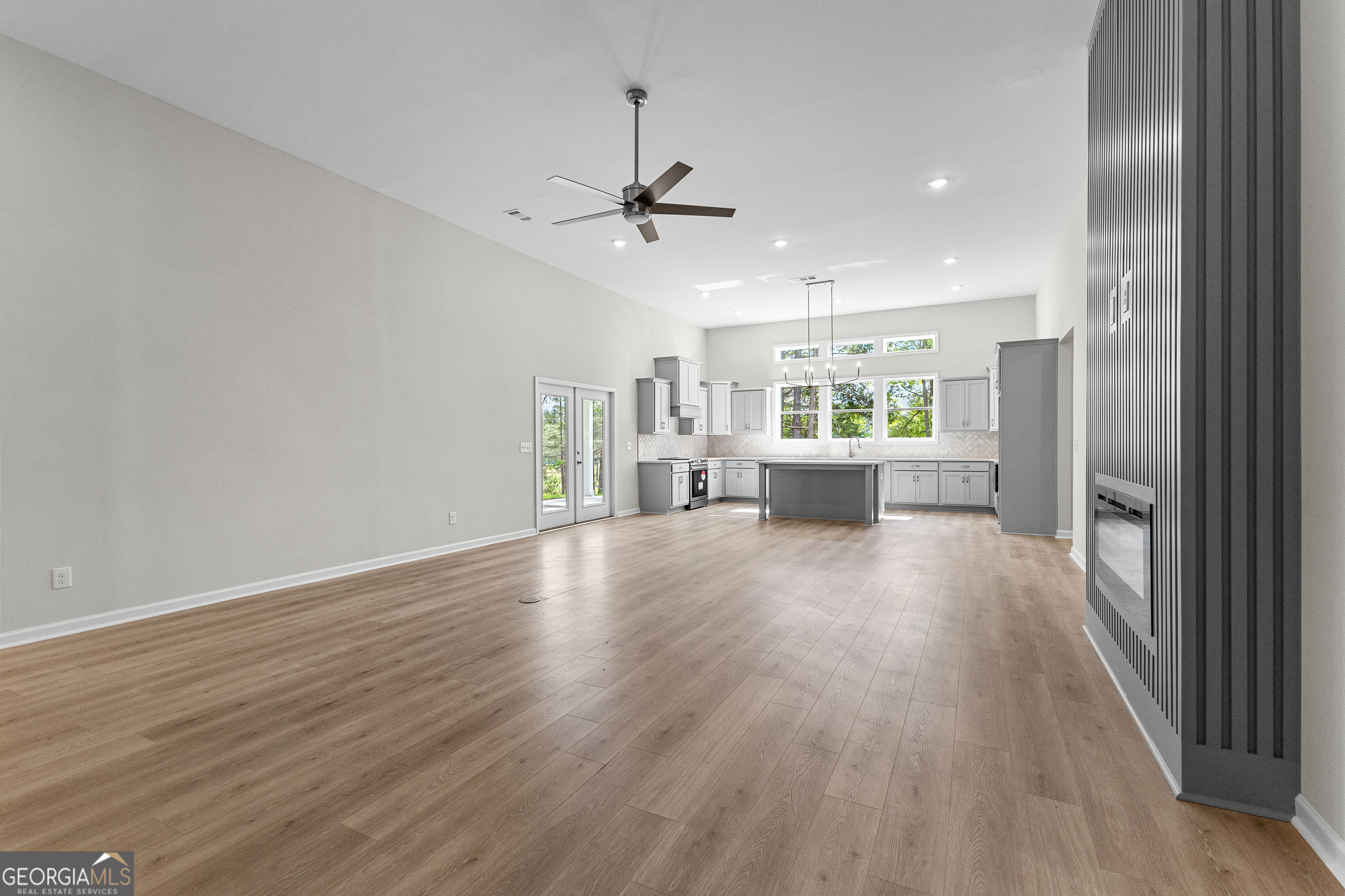 1242 Waymanville Road Thomaston, GA 30286 - Photo 11 of 52 wooden floor in an empty room with a kitchen