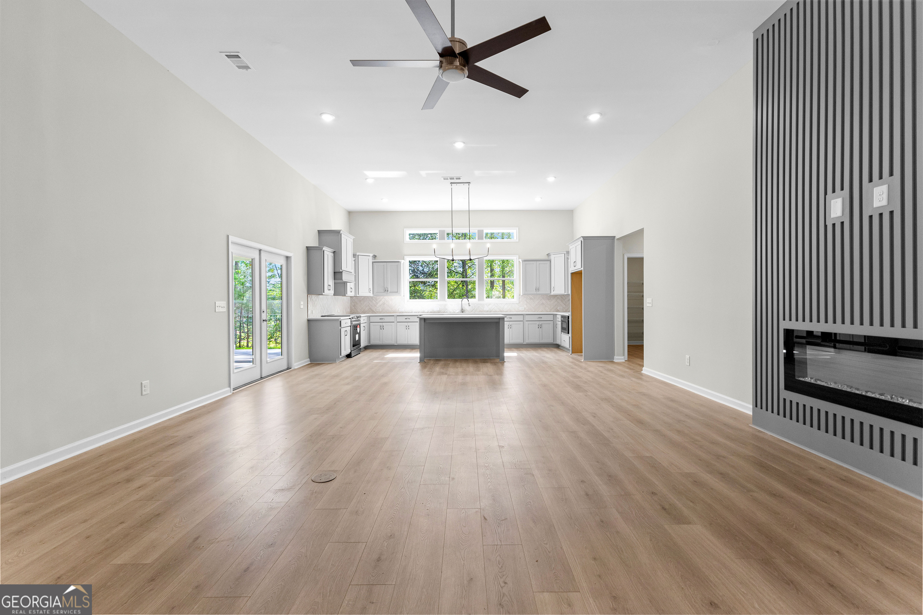 1242 Waymanville Road Thomaston, GA 30286 - Photo 12 of 52 an empty room with wooden floor and windows