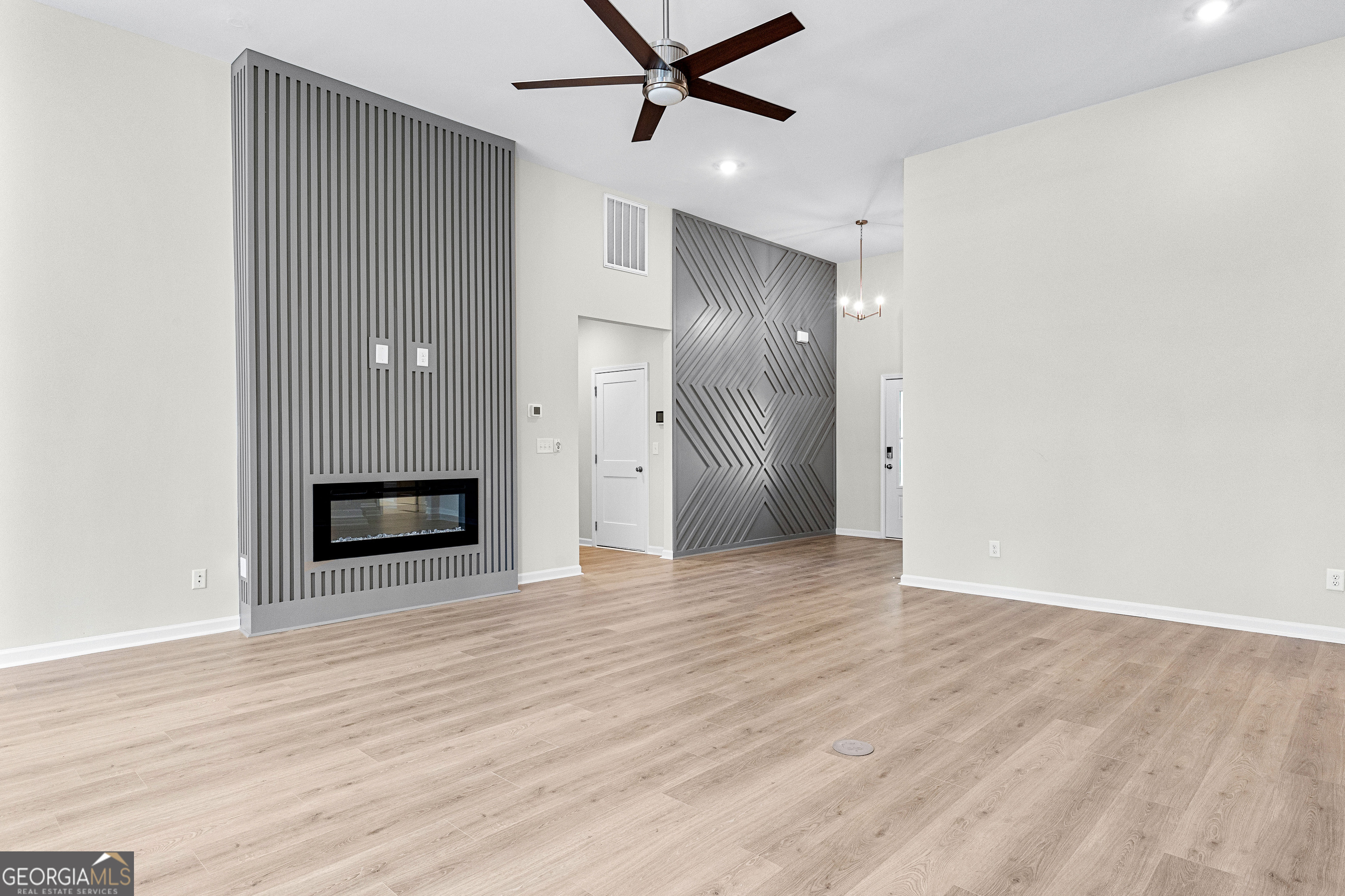 1242 Waymanville Road Thomaston, GA 30286 - Photo 15 of 52 a view of a livingroom with a ceiling fan a ceiling fan and wooden floor