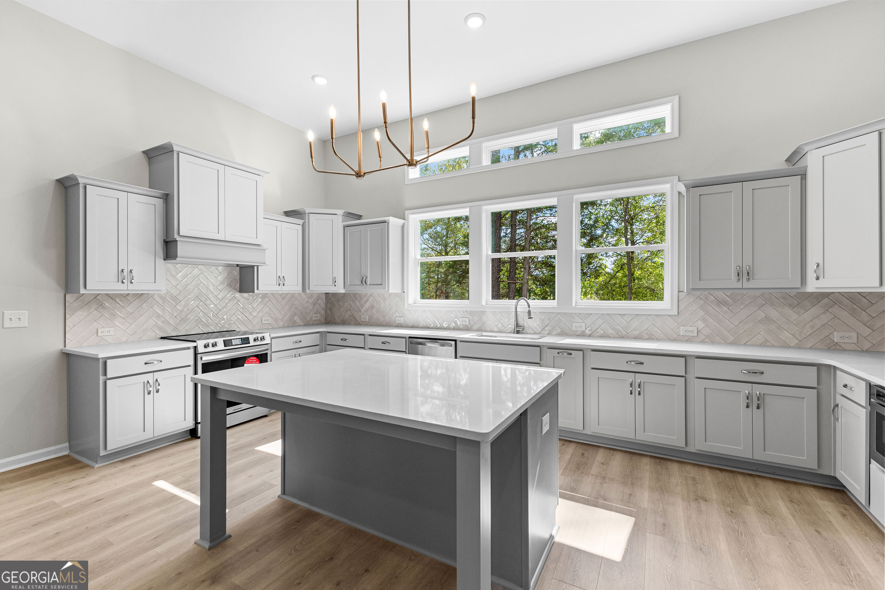 1242 Waymanville Road Thomaston, GA 30286 - Photo 18 of 52 a kitchen with stainless steel appliances granite countertop a sink a stove and a wooden floors