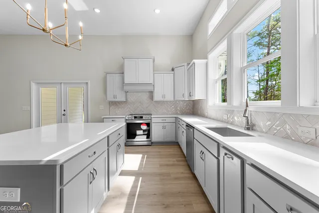a kitchen with a sink stove and cabinets