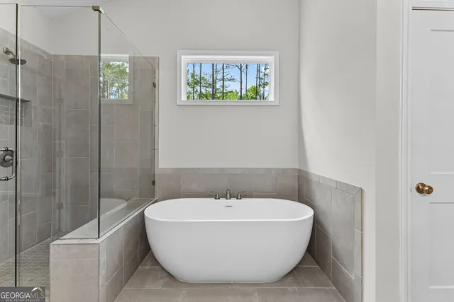 a bathroom with a bathtub and shower