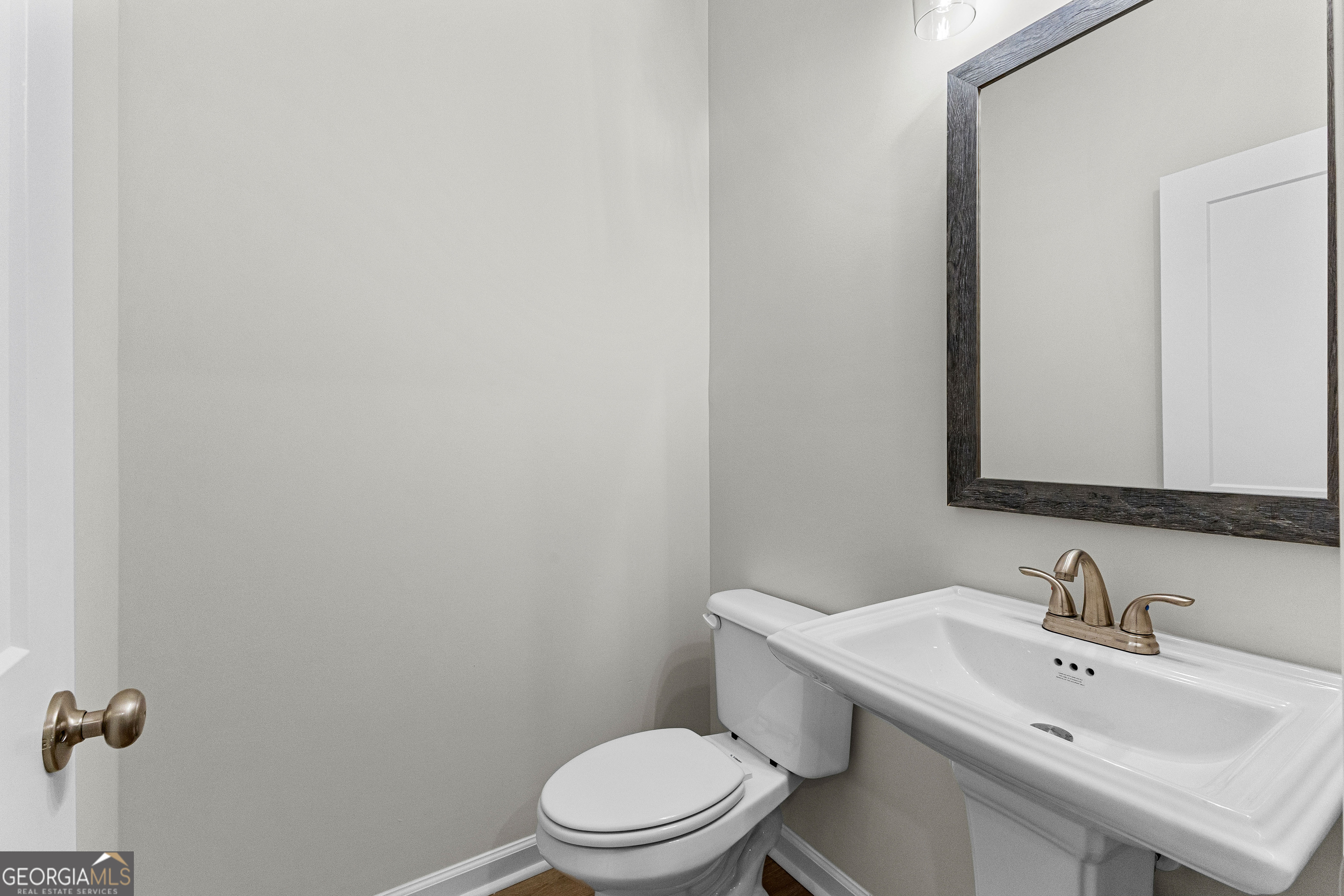 1242 Waymanville Road Thomaston, GA 30286 - Photo 35 of 52 a bathroom with a sink a toilet and mirror