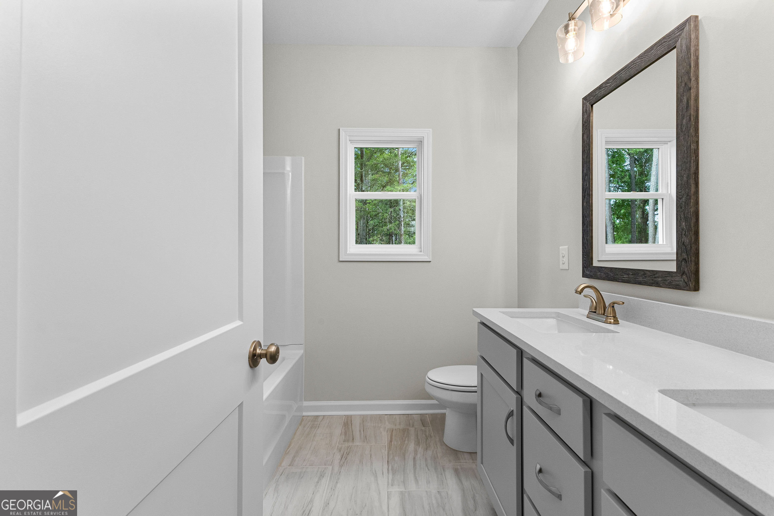 1242 Waymanville Road Thomaston, GA 30286 - Photo 39 of 52 a bathroom with a sink a toilet and a window