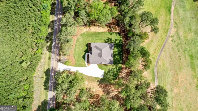 an aerial view of a house with a yard and garden