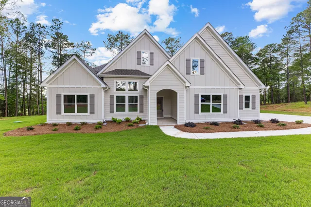 a front view of a house with a yard and porch