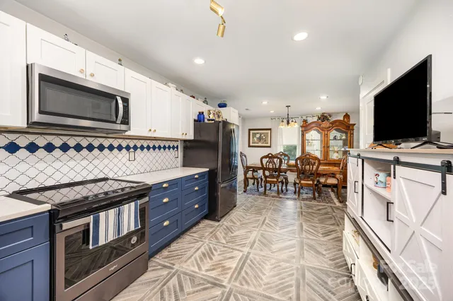 a kitchen with stainless steel appliances granite countertop a stove and a sink
