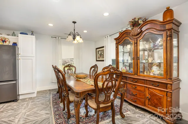 a view of a dining room with furniture and a chandelier