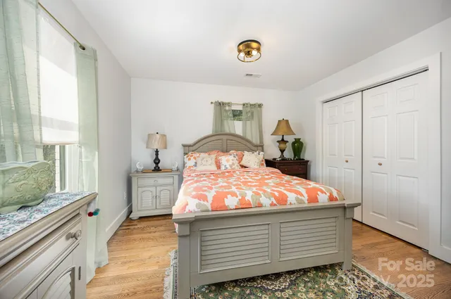 a bedroom with a bed and a window with the outer view