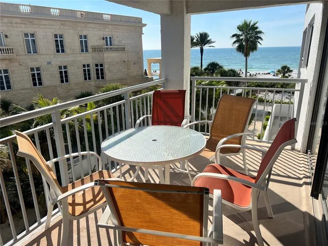 a view of a chairs and table in the balcony