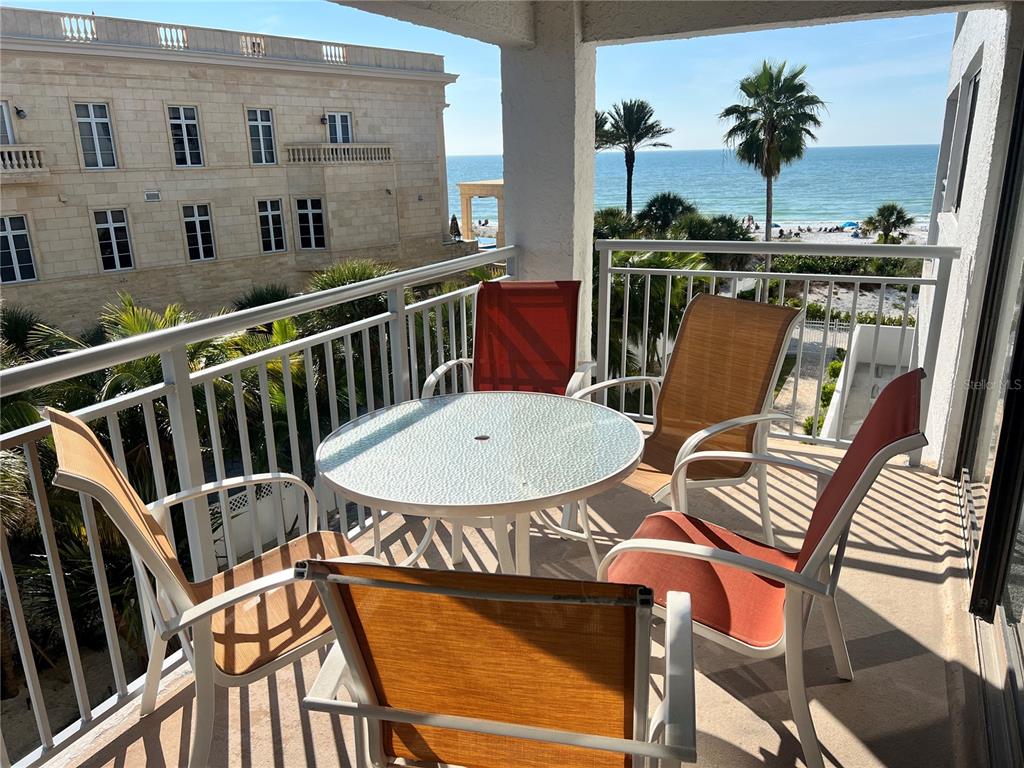 a view of a chairs and table in the balcony