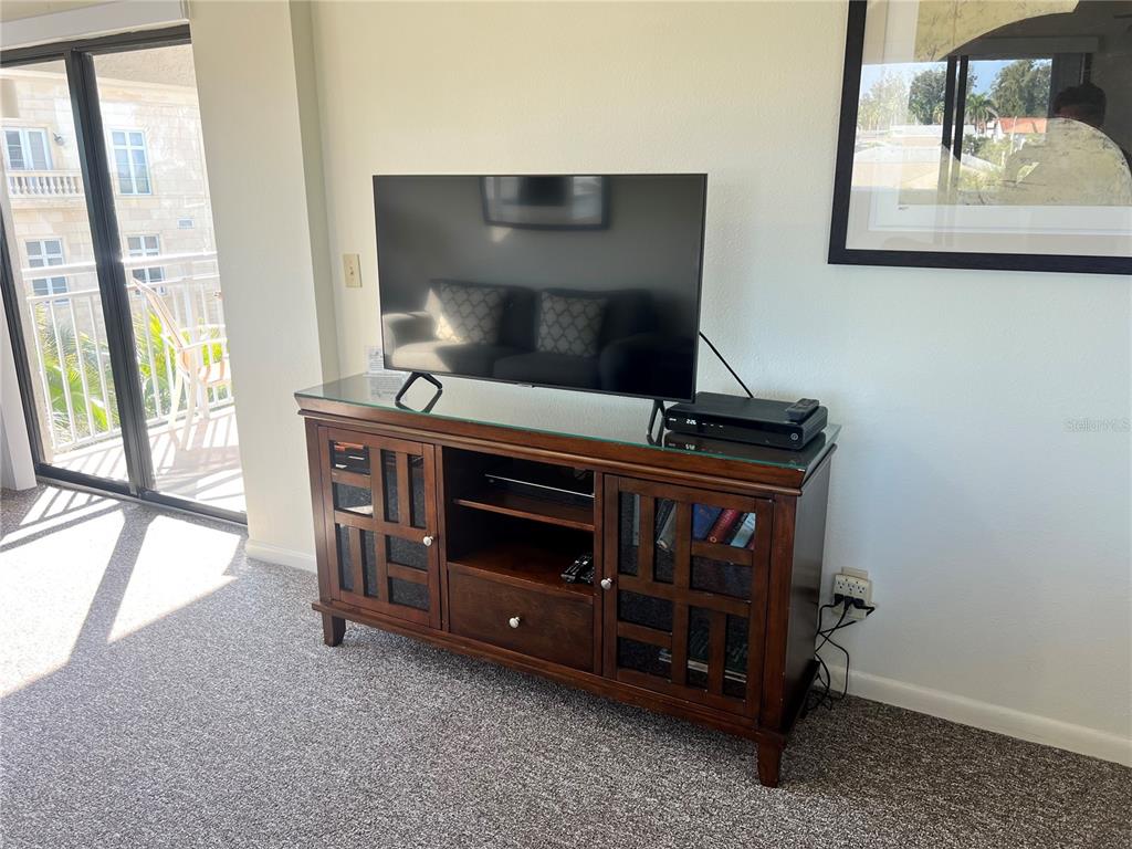1001 Point Of Rocks Road, Unit 408 Sarasota, FL 34242 - Photo 11 of 34 a living room with furniture and a fireplace