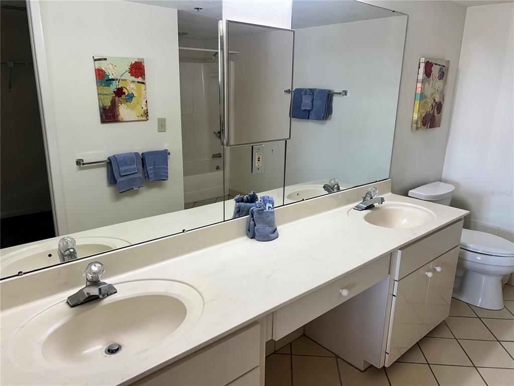 1001 Point Of Rocks Road, Unit 408 Sarasota, FL 34242 - Photo 14 of 34 a bathroom with a sink and a mirror