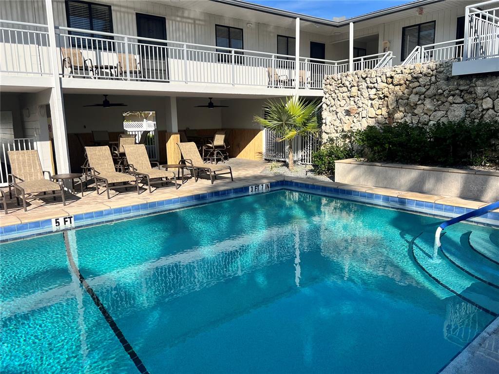 1001 Point Of Rocks Road, Unit 408 Sarasota, FL 34242 - Photo 21 of 34 a front view of house with yard and seating area