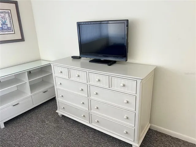 a room with cabinets and flat screen tv