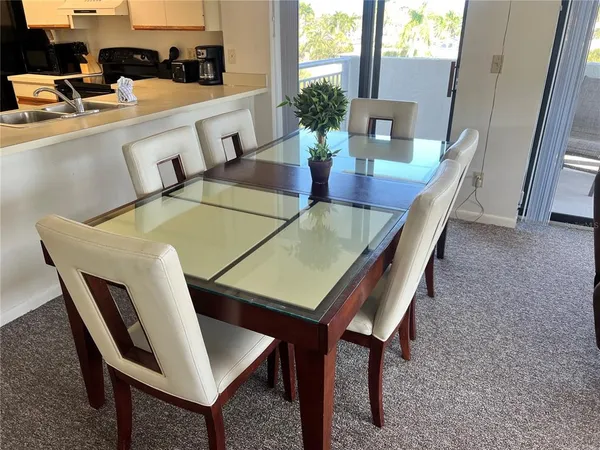 a dining room with furniture and wooden floor