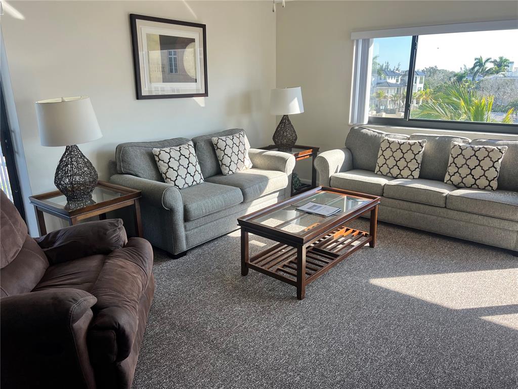 1001 Point Of Rocks Road, Unit 408 Sarasota, FL 34242 - Photo 10 of 34 a living room with furniture and a large window