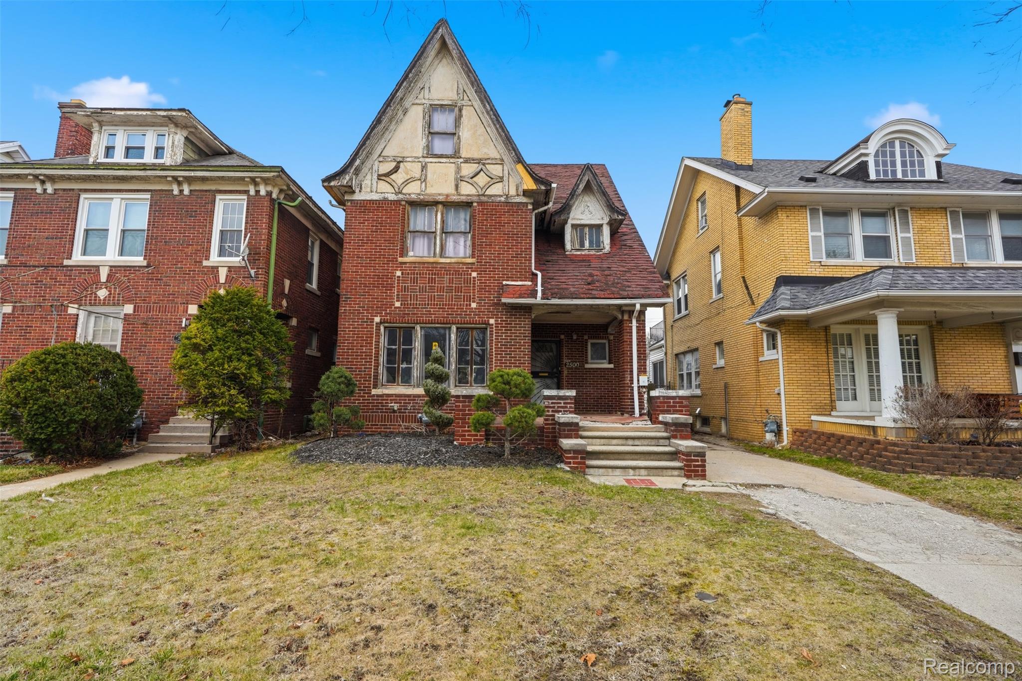 Tudor house with a front yard and brick siding