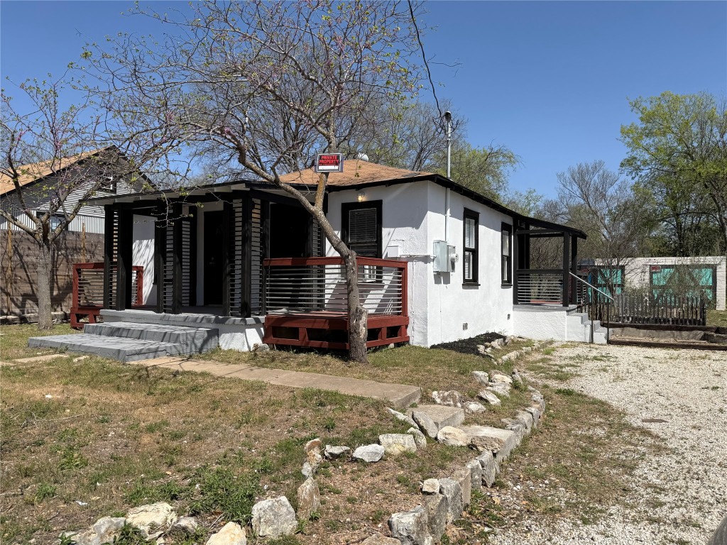 a view of a house with a yard covered in snow