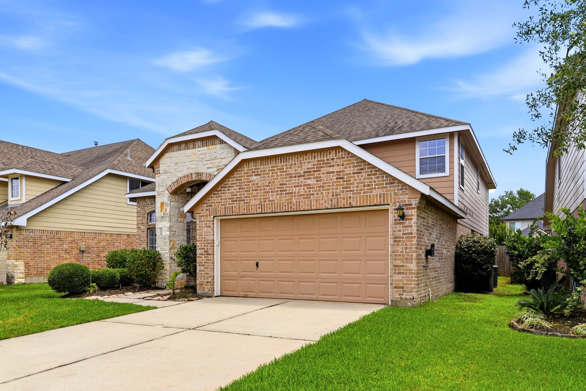 22102 Bridgestone Crossing Drive Spring, TX 77388 - Photo 2 of 38 a front view of a house with a yard and garage