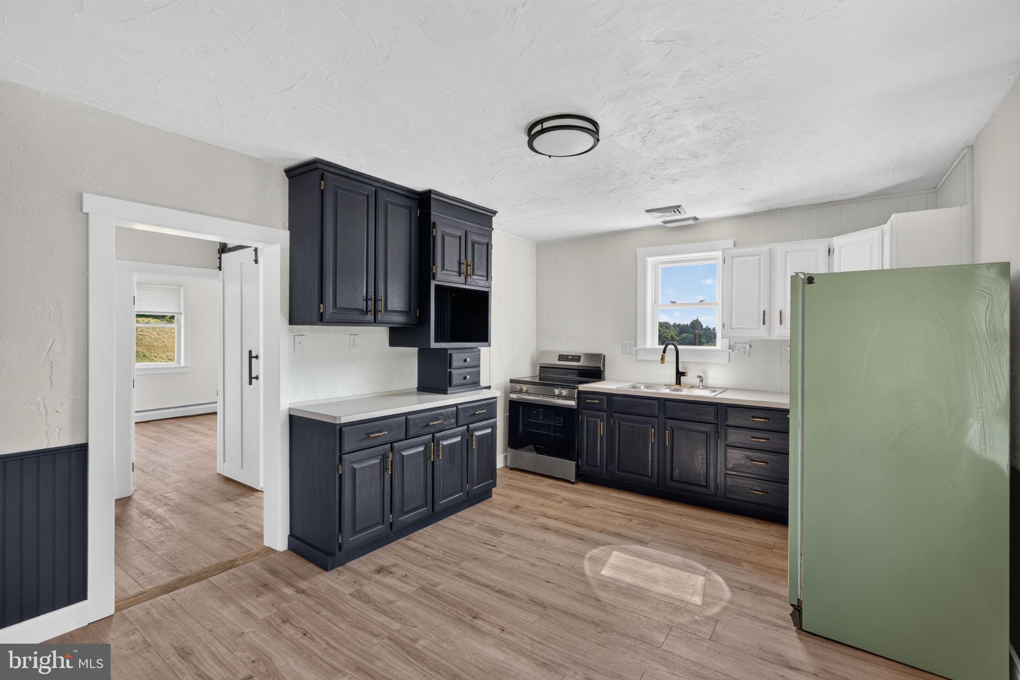 140 Limekiln Road Reading, PA 19606 - Photo 24 of 37 a kitchen with stainless steel appliances granite countertop a refrigerator a stove and a wooden floors