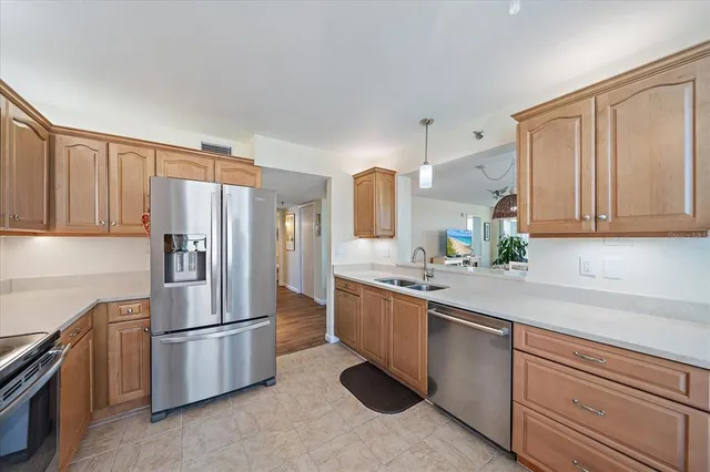 a kitchen with stainless steel appliances granite countertop a refrigerator sink and cabinets
