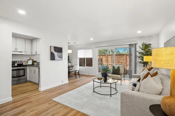 a living room with furniture and a wooden floor